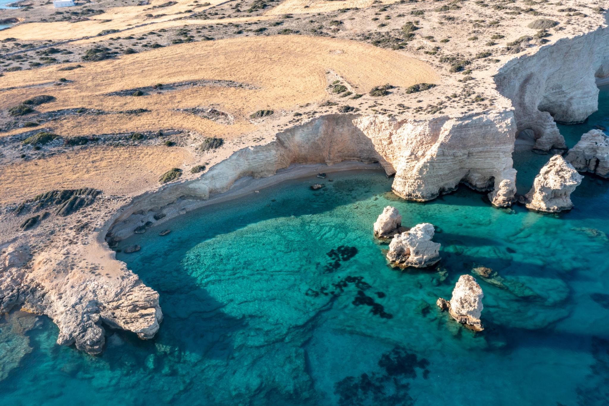 Hidden beaches Europe showing dramatic limestone coast and clear blue sea