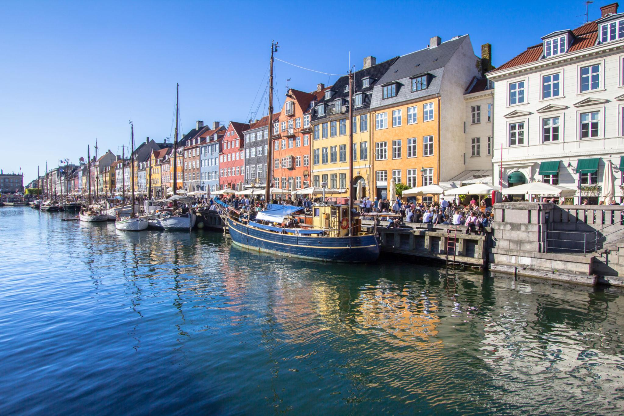 Copenhagen travel guide waterfront scene with boats and old buildings