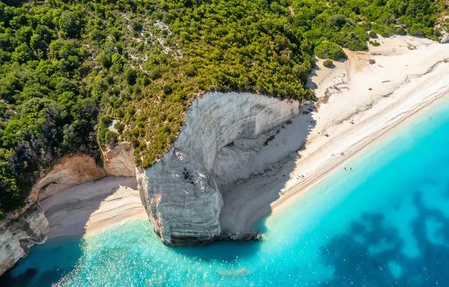 Hidden beaches Europe showing cliffs beside a quiet sandy beach