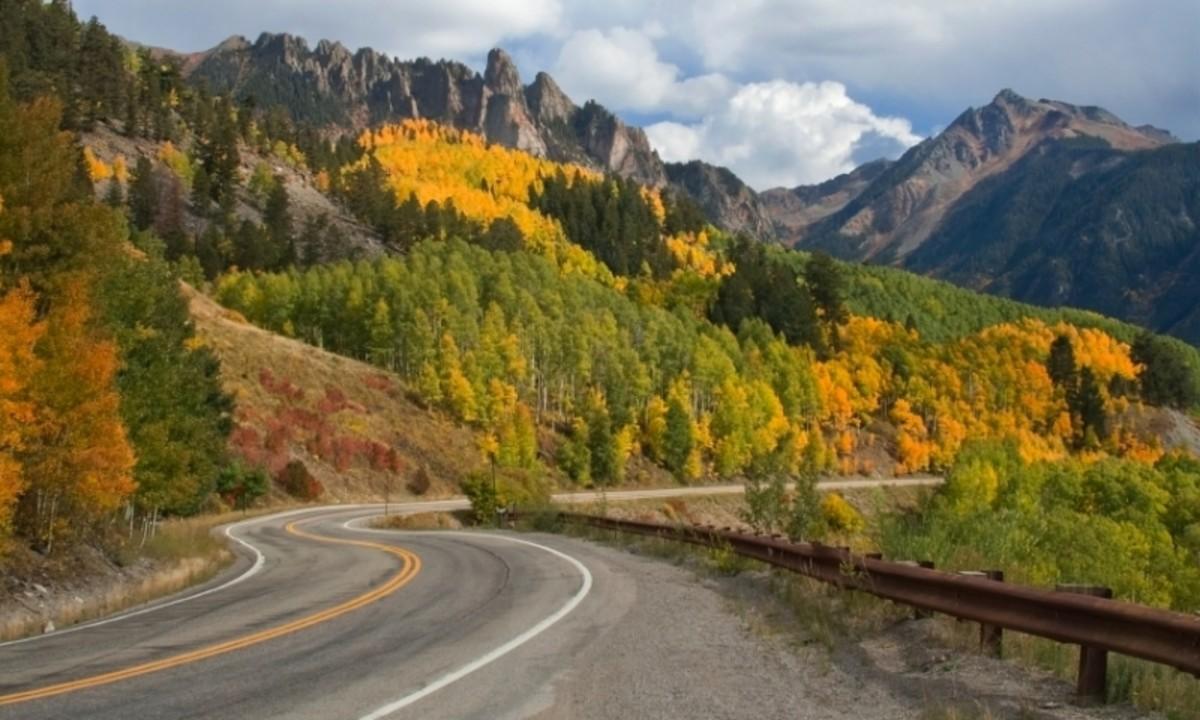 Autumn scenic drive in Colorado with golden aspen covered hills