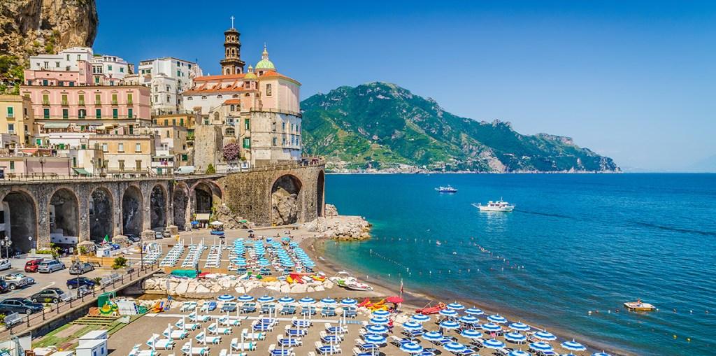 Best beaches Amalfi Coast village shoreline with boats and umbrellas