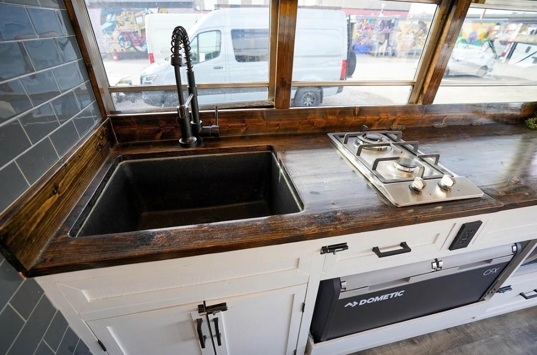 Compact bus camper kitchen setup