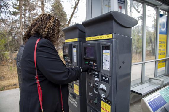 Person using transit card machine