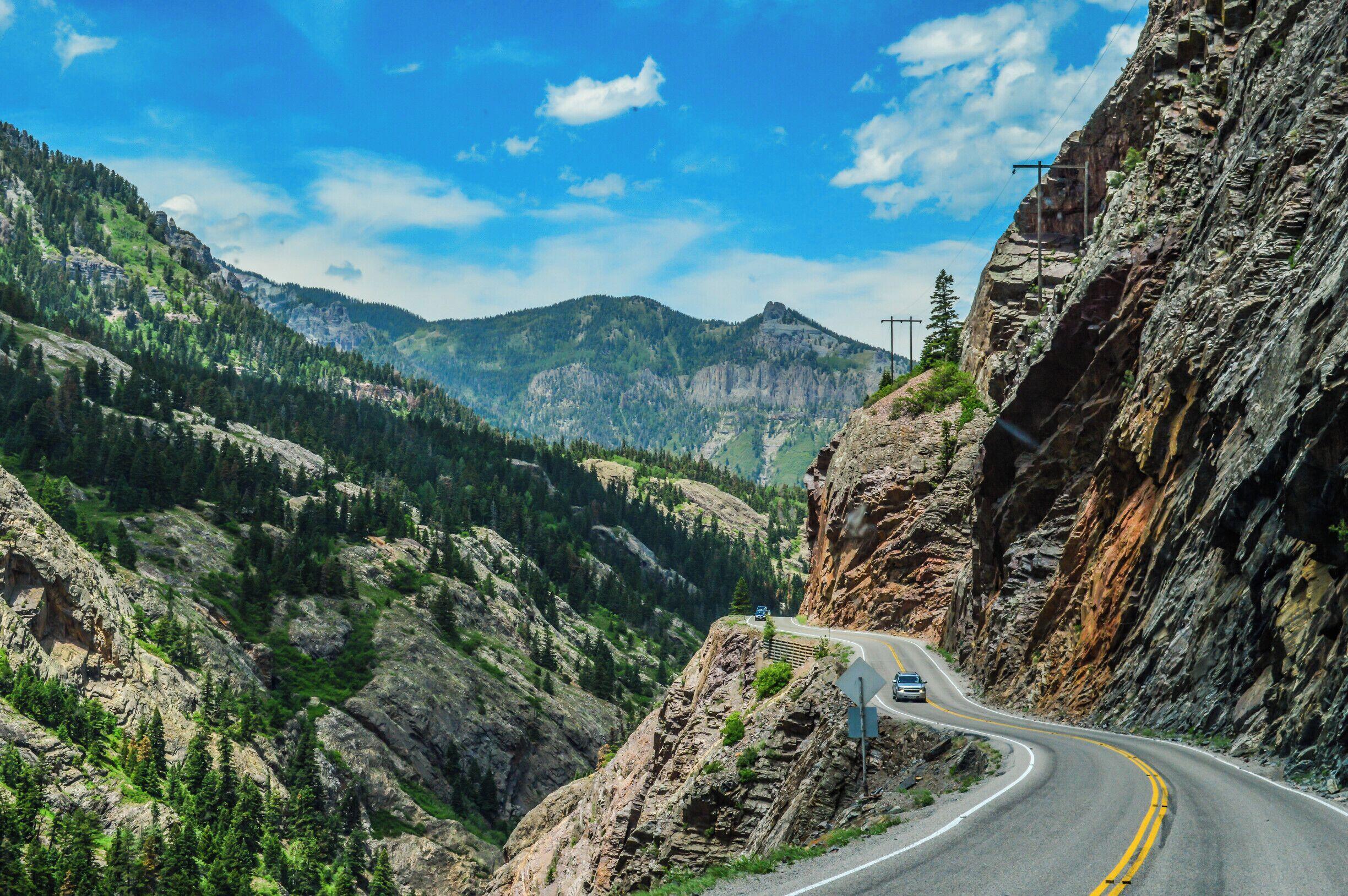 Colorado canyon scenic drive beside rocky cliffs and forested mountains