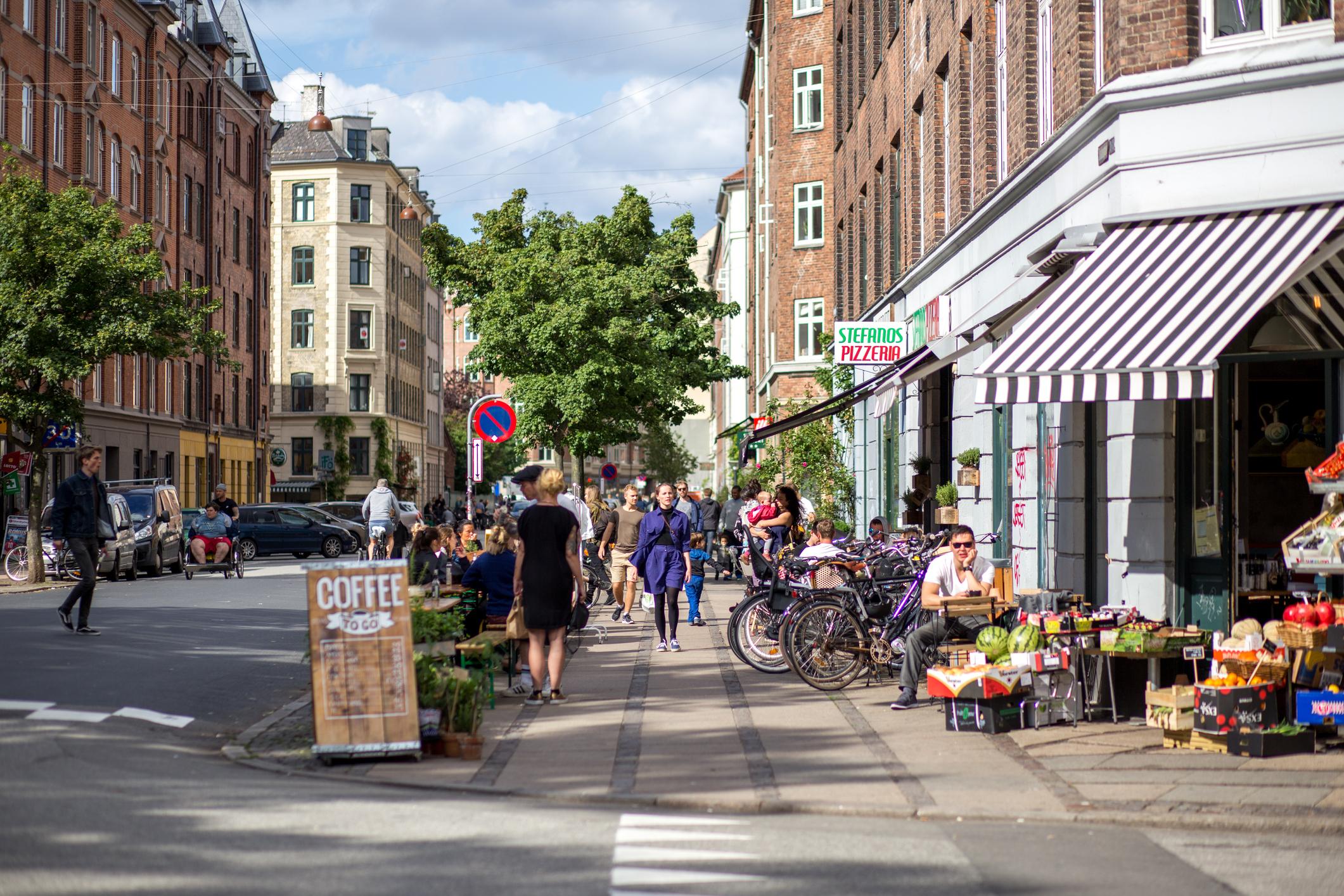 Copenhagen travel guide street scene with shops and bicycles