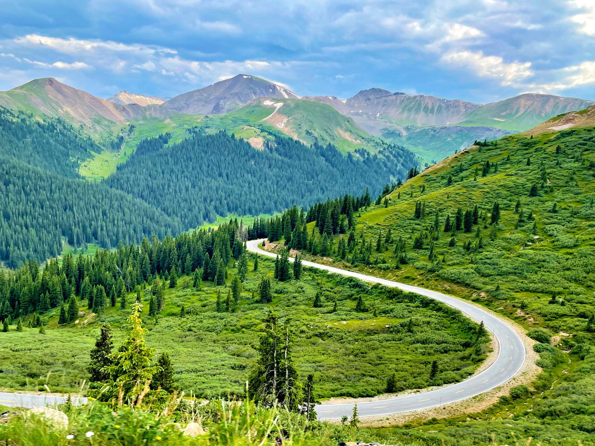 Green Colorado mountain scenic drive through forests and valleys