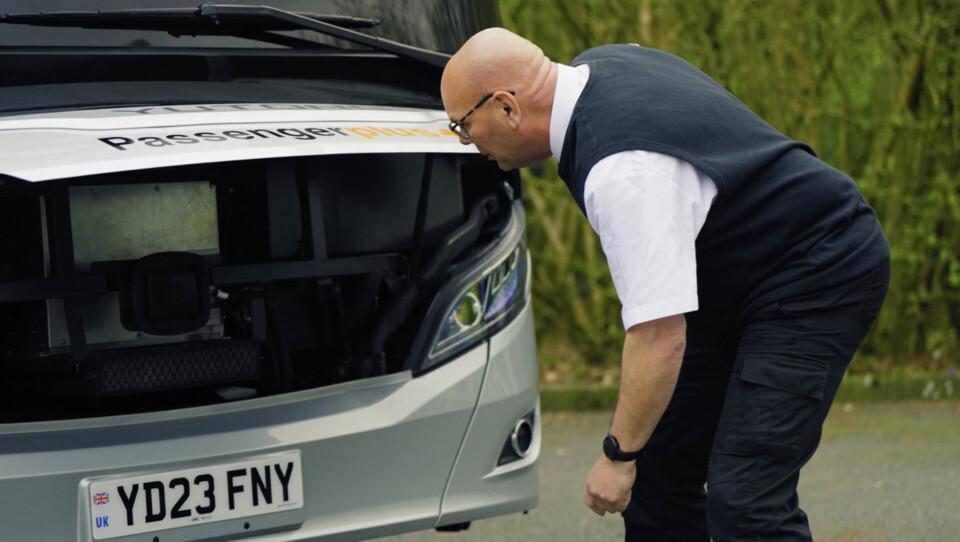 Driver inspecting charter bus safety