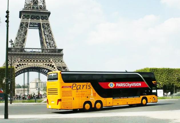 European tour bus near city landmarks