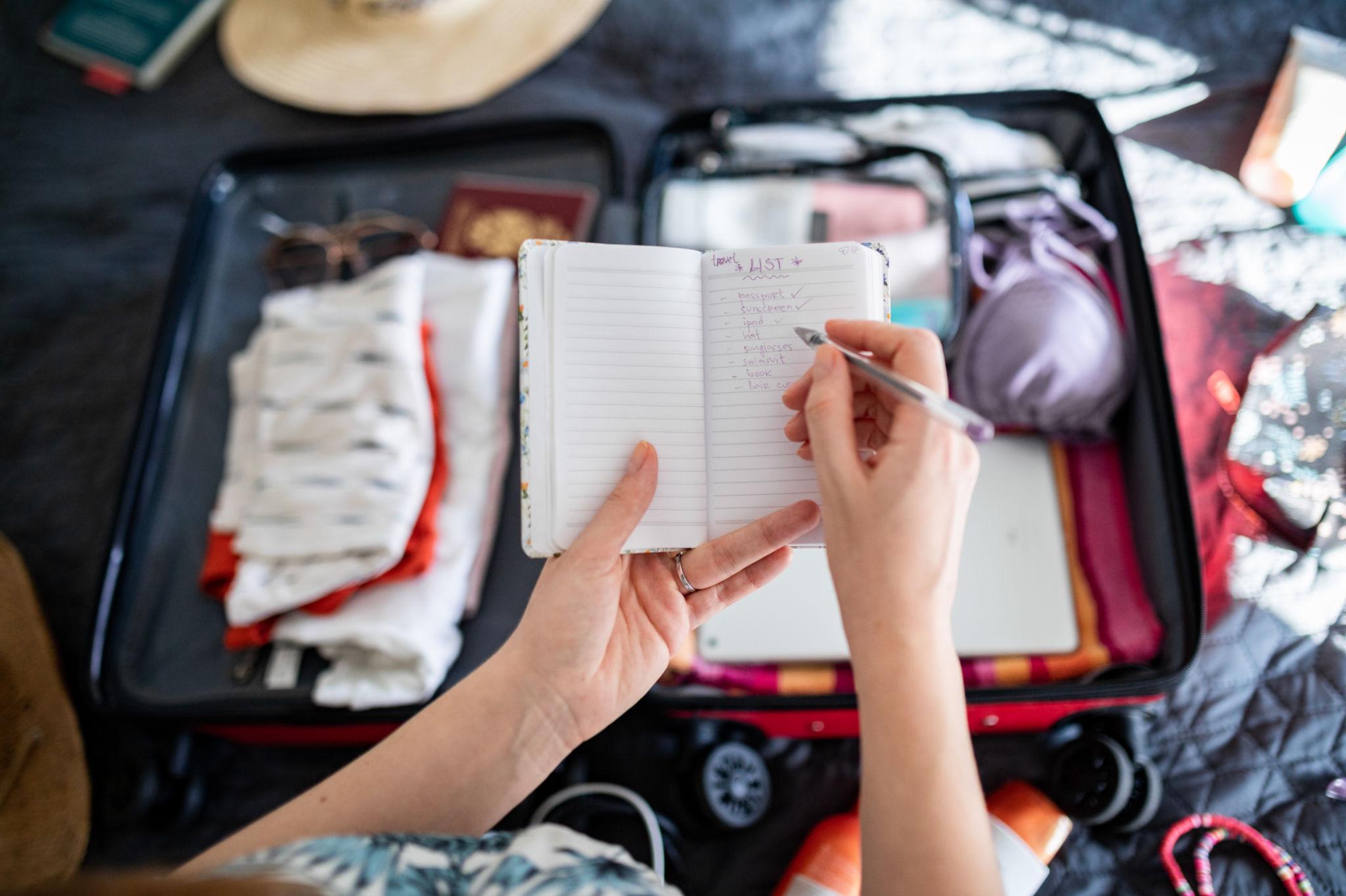 Open suitcase with travel checklist for organised packing preparation