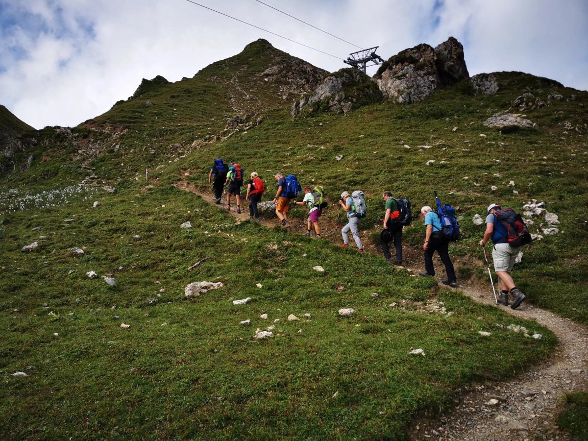 Friends hiking mountain trail together