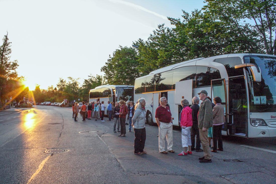 Travelers taking bus tour rest break