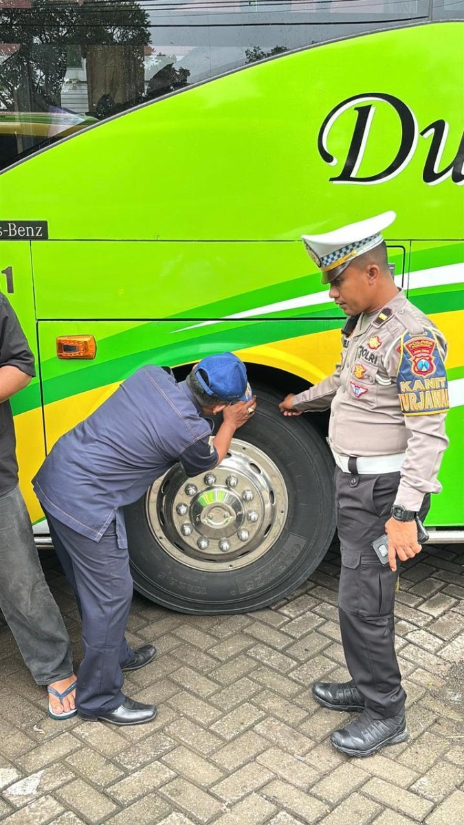 Driver checking tour bus safety