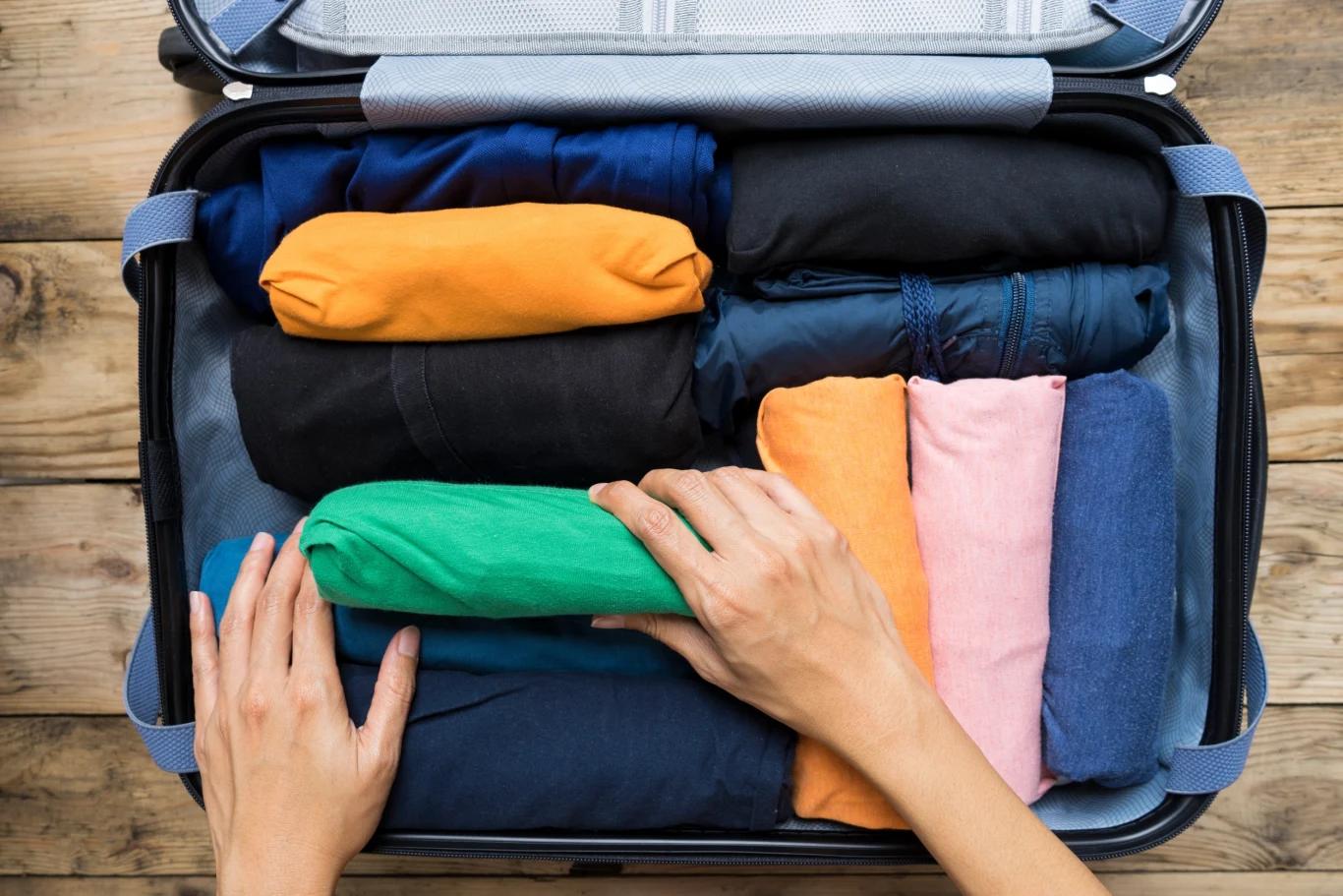 Rolled clothes inside suitcase showing space saving packing method