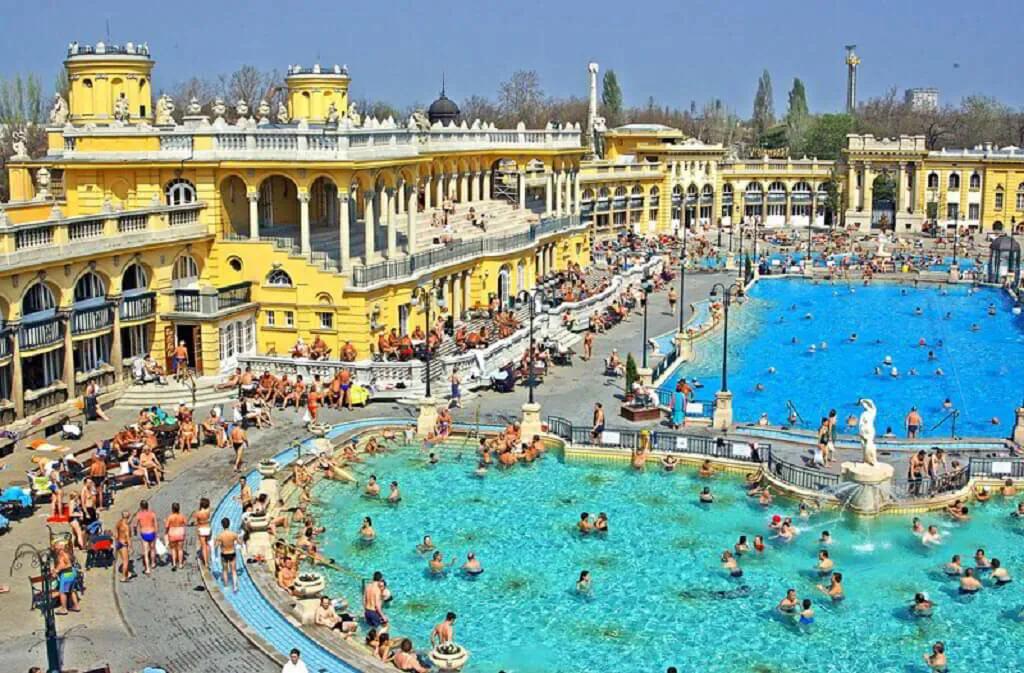 Budapest 3 day itinerary thermal bath pools with historic yellow architecture