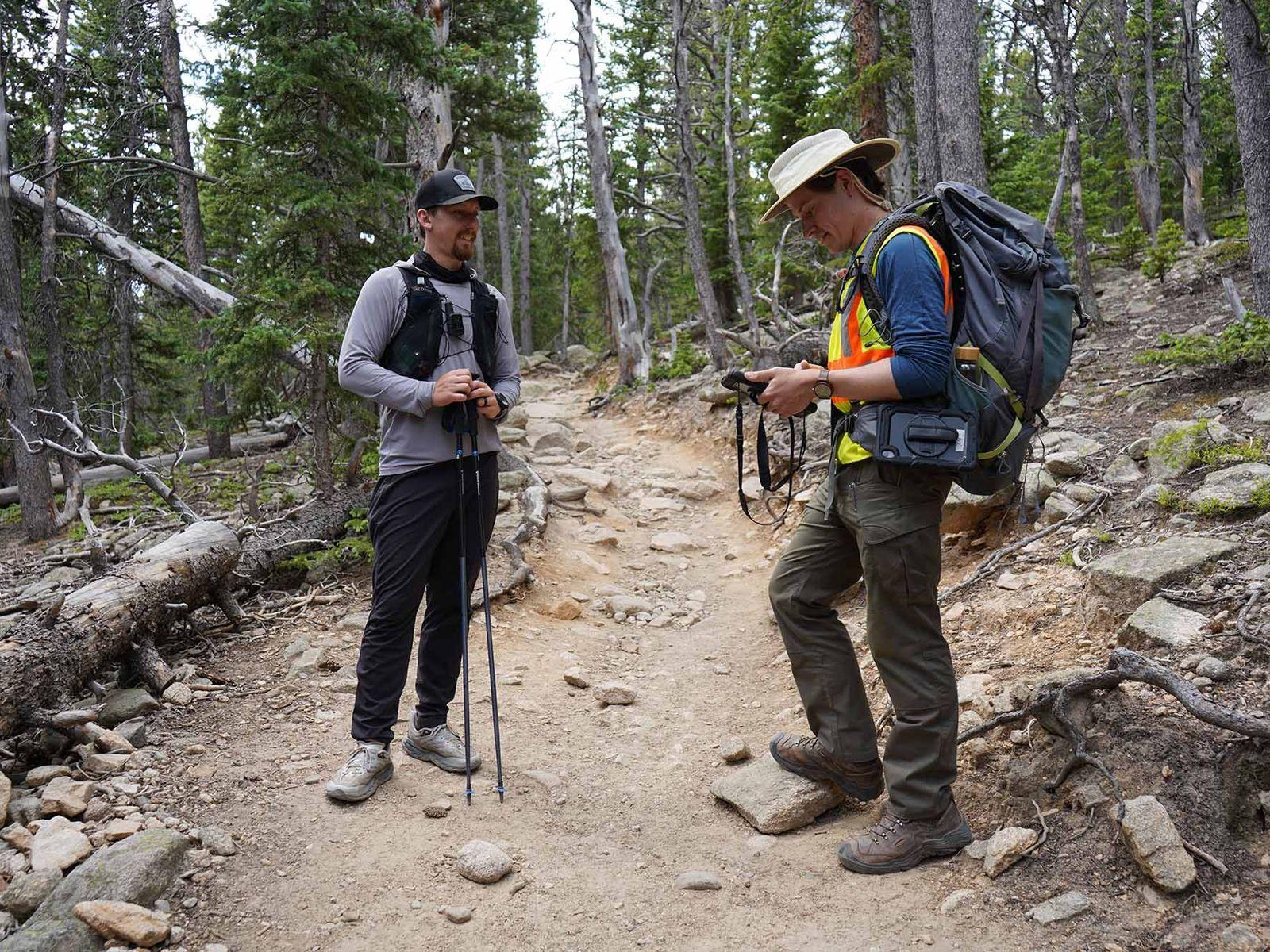 Hikers on a forest trail using a practical park checklist